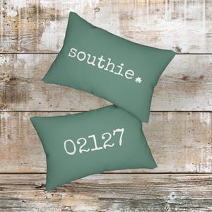 May include: A handmade wooden sign with the text "Welcome" in a whimsical font. The sign is painted white with a distressed finish, and features a decorative floral design in shades of pink and green. It is designed to be hung on a door or wall.