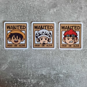 May include: Three wanted posters with cartoon characters. Each poster has the word "WANTED" at the top and "DEAD OR ALIVE" at the bottom. The first poster features a character with brown hair and a straw hat. The second poster features a character with a white and black bandana and a black eye patch. The third poster features a character with red hair and red goggles.