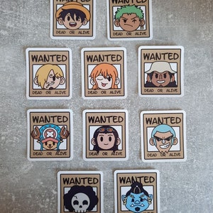 May include: Ten brown and beige wanted posters with cartoon characters from the anime One Piece. Each poster has the word "WANTED" at the top, a cartoon character's head in the middle, and the words "DEAD OR ALIVE" at the bottom.