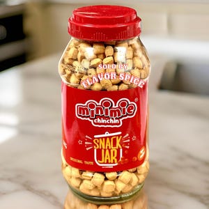 May include: A glass jar filled with mini chichin snack crackers. The jar has a red label with the words "Minnie Chichin Snack Jar" and "Sold by Flavor Spice".