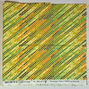 May include: Yellow fabric with a repeating pattern of small, multi-colored circles. The fabric has a label that reads "acacia by Tula PINK TM for  Jane  Street Westminster Fibers # PWTP 042 Pixel Dot".