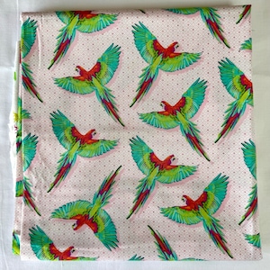Tula Pink&#39;s Daydreamer - one fat quarter cut of the &quot;Macaw ya Later&quot; print, featuring macaws on a pink geometric background.