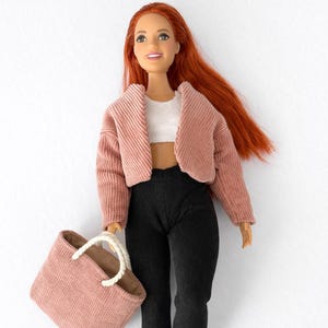 May include: A white ceramic mug with a black handle and the text "But First, Coffee" in a black, bold font. The mug is likely 11-15 ounces and is suitable for hot beverages.