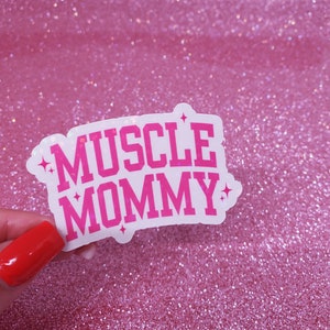 May include: A white sticker with pink lettering that reads "MUSCLE MOMMY" with glitter accents.
