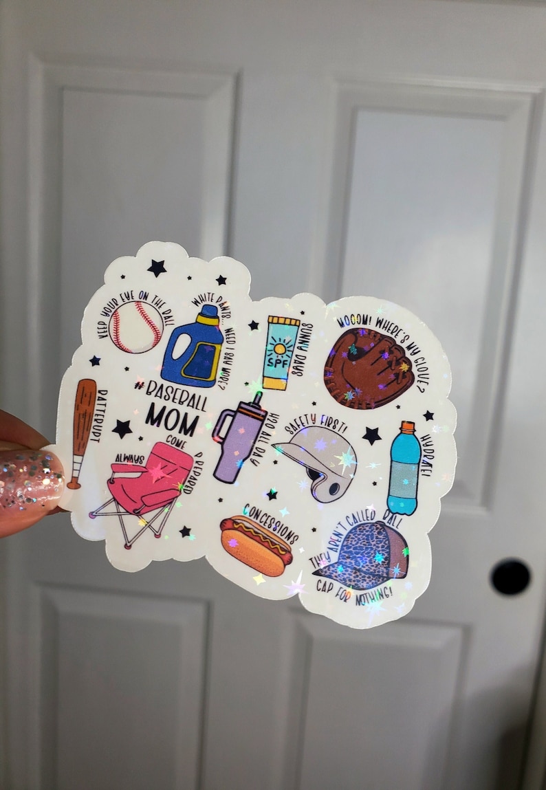 May include: A white sticker with a baseball theme. It features a baseball, a baseball glove, a bat, a chair, a water bottle, a hot dog, a baseball cap, a helmet, sunscreen, and a bottle of detergent. The sticker has the text "#Baseball Mom Come Prepared Always Safety First! They Aren't Called Ball Cap For Nothing!"