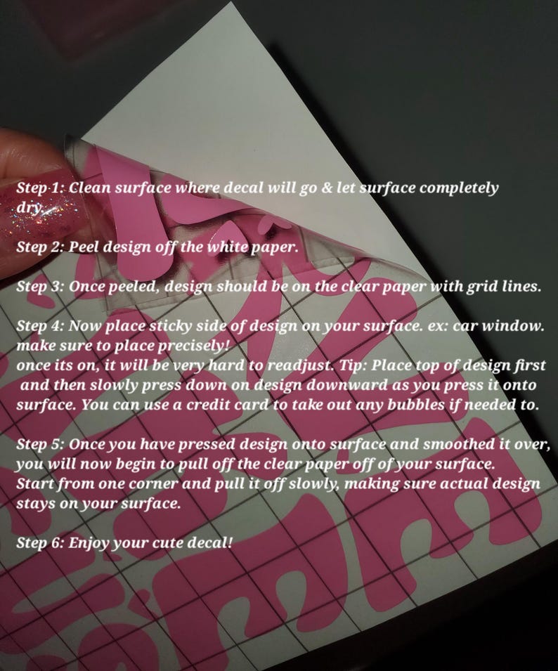 May include: A pink decal being applied to a surface. The image shows the steps for applying the decal, including cleaning the surface, peeling the design, and smoothing it onto the surface. The text in the image provides instructions.