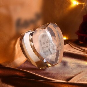 May include: A crystal heart-shaped paperweight with a 3D image of a child inside. The image is engraved with the words "I Love You".