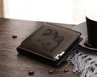 May include: A brown leather wallet with a personalized image of three people. The wallet is rectangular with a silver metal accent and a dark interior. Coffee beans are scattered around the wallet.