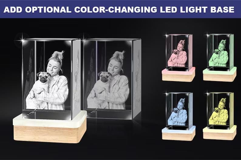 May include: A 3D crystal photo with a color-changing LED light base. The crystal shows a person holding a dog. The base has a wooden frame and comes in a variety of colors, including pink, green, blue, and yellow.