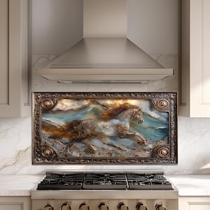 May include: A framed artwork depicting a running horse with a flowing mane, set against a backdrop of ocean waves. The artwork features shades of brown, blue, and gold, and is encased in a decorative, dark brown frame. The artwork is mounted above a kitchen stove.