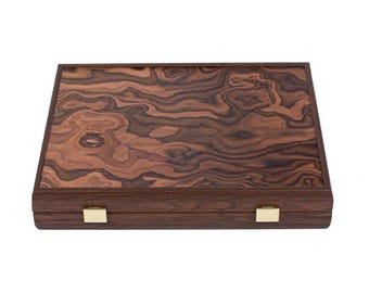 May include: A wooden game box with a dark brown wood grain pattern and brass hinges. The box is closed.
