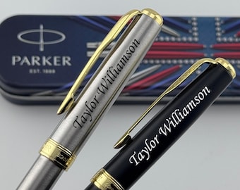 May include: Two Parker Sonnet pens with gold-tone clips and trim. One pen has a brushed stainless steel finish, and the other has a matte black finish. Both pens are engraved with the name Taylor Williamson in a script font on the cap.