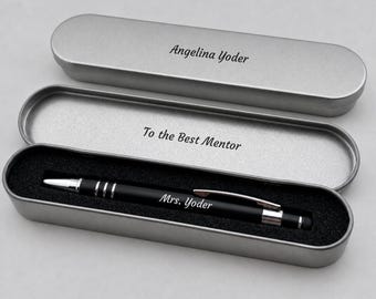 May include: A black ballpoint pen with silver accents and the name Mrs. Yoder engraved on the barrel, resting in a silver metal case. The lid is engraved with Angelina Yoder, and the interior base features the text To the Best Mentor.