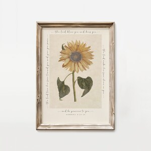 May include: A framed print featuring a vintage illustration of a sunflower. The print includes the text "The Lord bless you and keep you... and be gracious to you. Numbers 6:24-26"