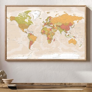 May include: A framed world map with a vintage aesthetic. The map features a beige background with countries in shades of green, orange, and red. The wooden frame adds a classic touch. The map is a decorative piece for home or office.