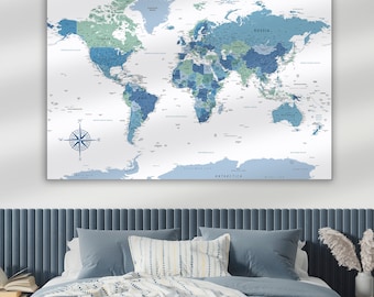 May include: A blue and green world map with country names and borders printed on a white background. The map is hanging on a white wall above a blue headboard with a white and blue patterned pillow.