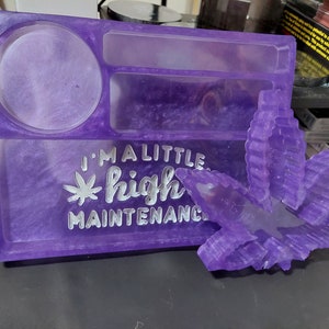 May include: Purple resin tray with a round compartment, two rectangular compartments, and a leaf design. The tray has the text "I'm a little high maintenance" written on it.