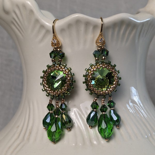 Green and gold beaded earrings with dangling crystals