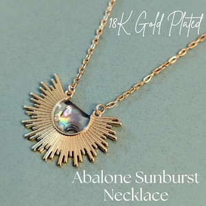 May include: An 18K gold-plated necklace featuring a sunburst pendant with an abalone shell center. The pendant has a radiant design with a chain. The text on the image reads "Abalone Sunburst Necklace".