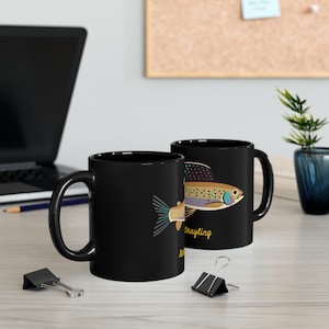 May include: Two black ceramic mugs featuring a trout illustration and the text "Fly Fishing" and "Trout Fishing".