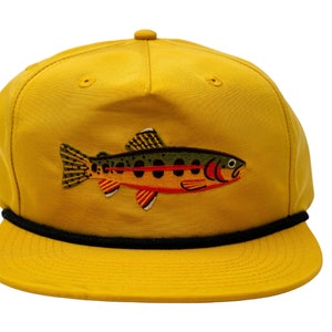 May include: A yellow baseball cap with a black rope trim and an embroidered trout design.