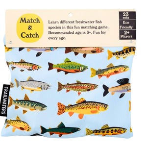 May include: A blue pouch with a colorful fish pattern and the text "Match & Catch" on the front. The pouch is labeled "Trailwaters" and has the text "23 sets, Eco Friendly, 2+ Players" on the back.