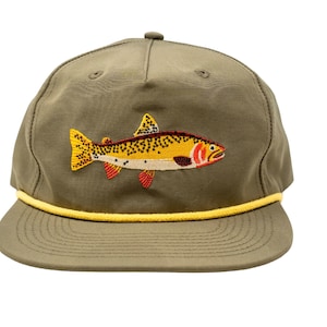 May include: A green and yellow baseball cap with an embroidered trout design. The trout is yellow, orange, and black with red fins.