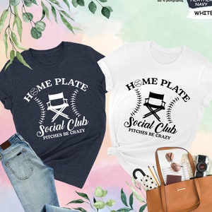 a couple of shirts that are next to a purse