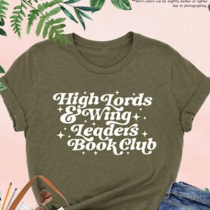 May include: A green heather t-shirt with white text that reads "High Lords & Wing Leaders Book Club".