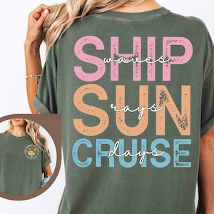 May include: Moss green t-shirt with the words "SHIP, SUN, CRUISE" in pink, orange, and blue. The words "waves" and "rays" are written in white script. A small image of a boat is on the front.