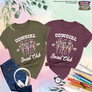 two cowgirl social club t - shirts on a table