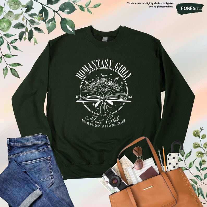 May include: A dark green sweatshirt with a white graphic design of a book with flowers and the text "Romantasy Girl Book Club Est 1969 Where Dragons and Hearts Collide"