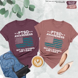 two t - shirts with the words ptsd awareness and not all wound are visible