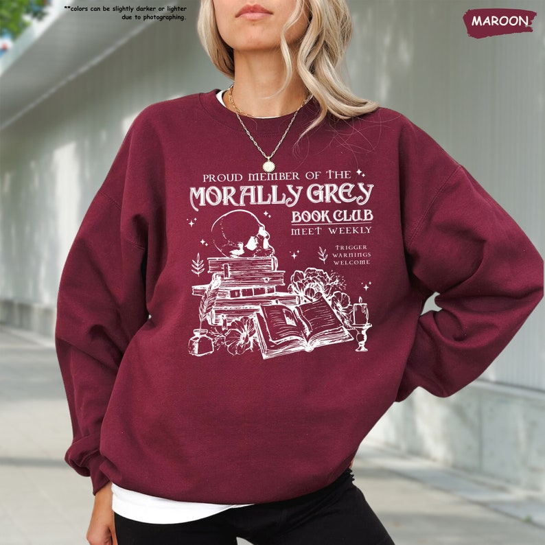 a woman wearing a maroon sweatshirt and black pants