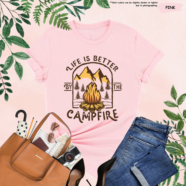 a pink shirt that says life is better at the campfire