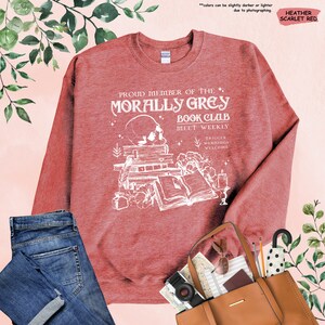a red sweatshirt with a picture of a train on it