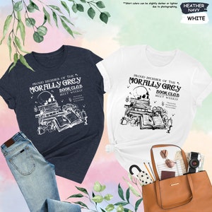 a couple of t - shirts and a purse on a table
