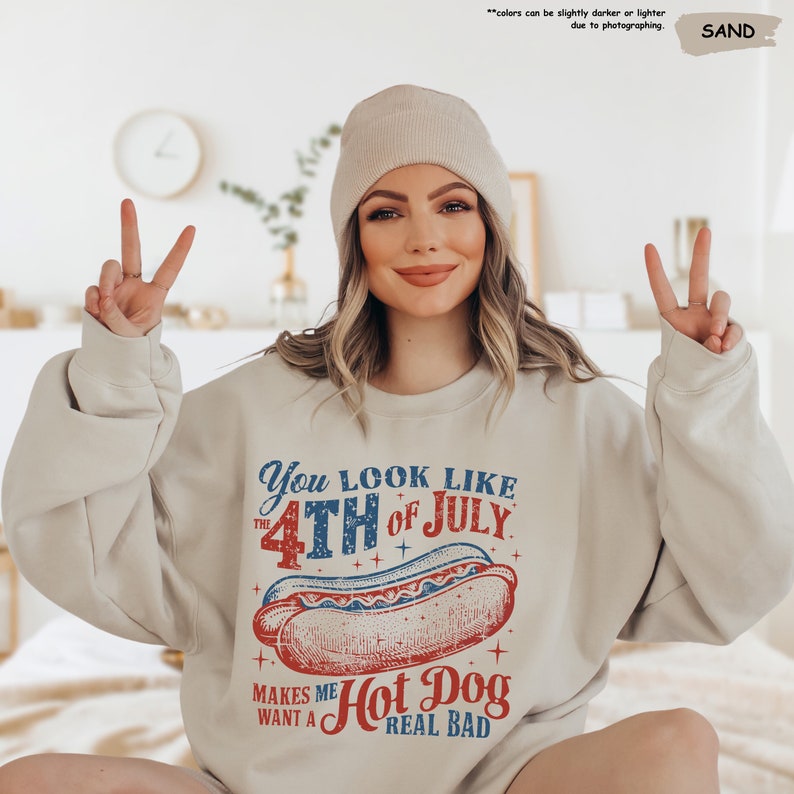 a woman wearing a sweatshirt with a hot dog on it