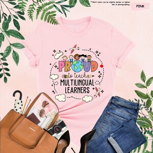 a pink t - shirt that says proud is a multilingual learner