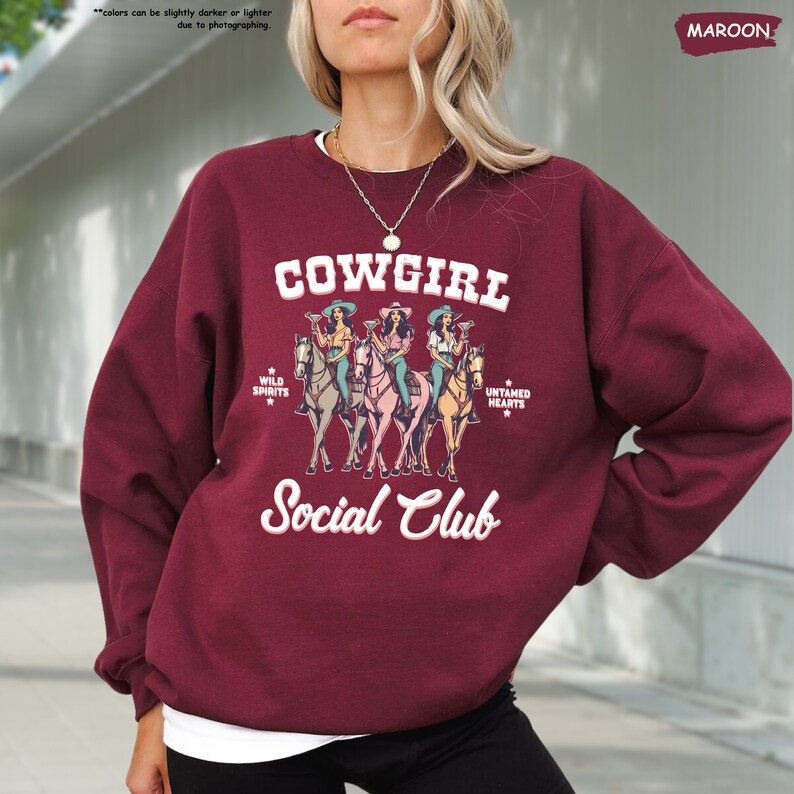 a woman wearing a cowgirl social club sweatshirt