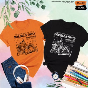 two t - shirts and headphones on a table