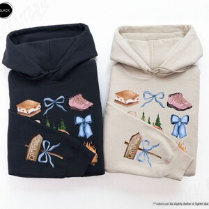 a couple of sweatshirts sitting on top of a white table