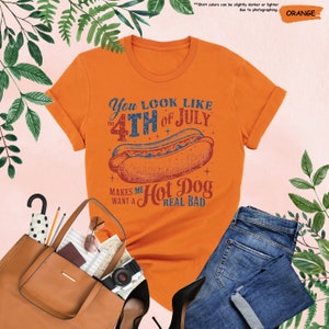 a women's orange shirt with a hot dog on it