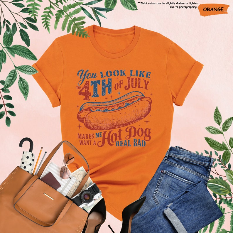 a women's orange shirt with a hot dog on it