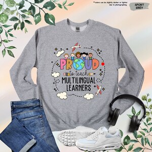 a sweatshirt with a pair of headphones next to it