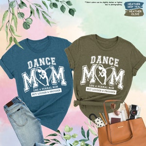 a couple of shirts that are next to a purse