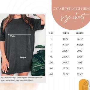 May include: A dark grey t-shirt with a size chart. The chart lists sizes S to 4XL, with measurements for width, length, and sleeve length in inches. The text "COMFORT COLORS" and "size chart" are at the top.