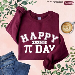 May include: A maroon sweatshirt with white text that reads "HAPPY 3.14.2025- PI DAY".