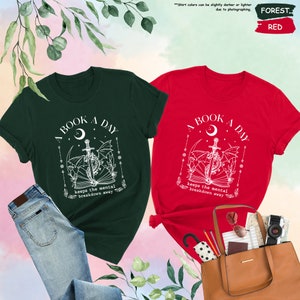 two t - shirts and a purse on a table