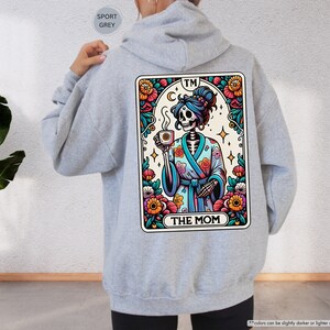 a person wearing a hoodie with a picture of a skeleton on it